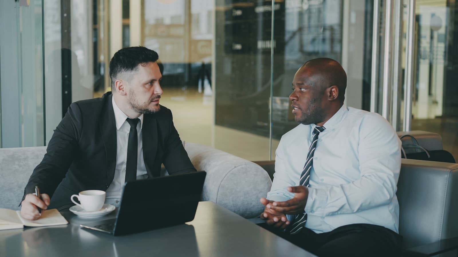 Two private equity operators discussing portfolio hiring strategy